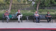 Four-men-on-benches-lined-up