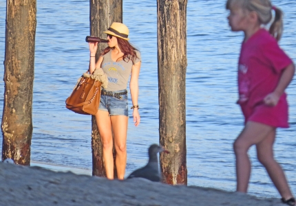 muscular girl drinking beer - Malibu beach